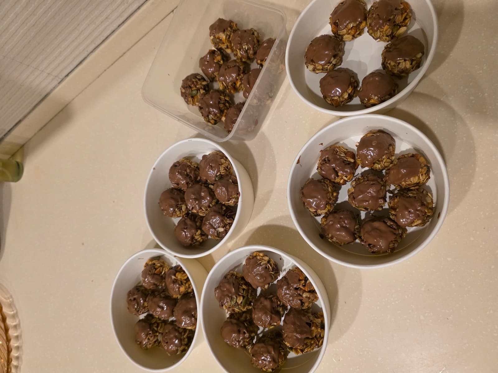 Energy bombs portioned into multiple bowls on a kitchen counter