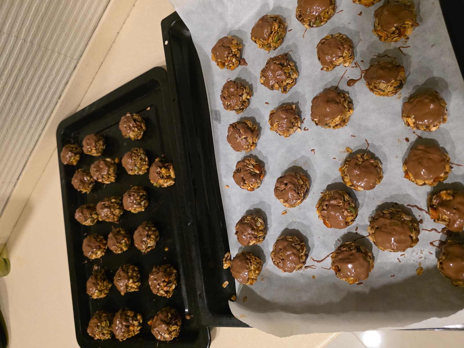 Two trays of freshly chocolate-dipped NutriHome energy bombs